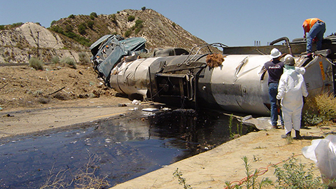 A Patriot Environmental Services team assesses the cleanup of spilled material from an overturned tanker truck