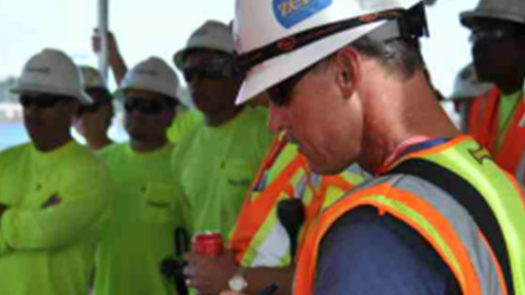 A Patriot Environmental Services field supervisor talks to his team about the waste cleanup project