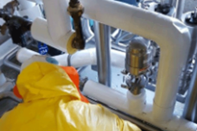 A Patriot Environmental Services technician works in an agriculture and food processing plant performing decontamination