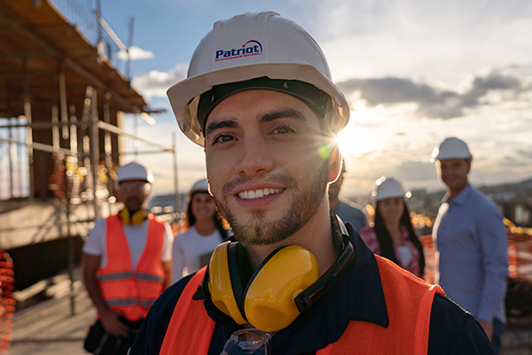 A Patriot Environmental Services field technician standing with coworkers