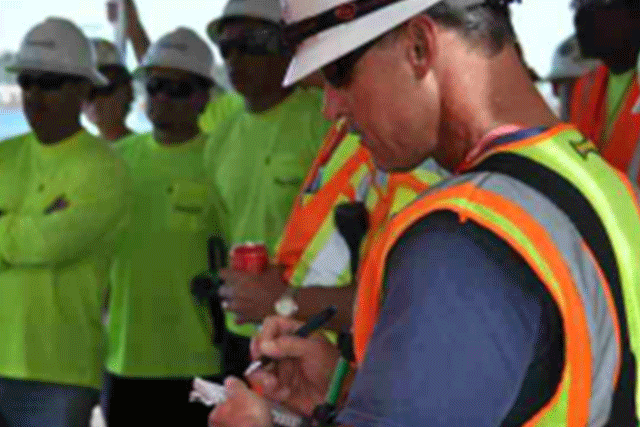 Members of a Patriot Environmental Services project management team prepare to implement their operational plan