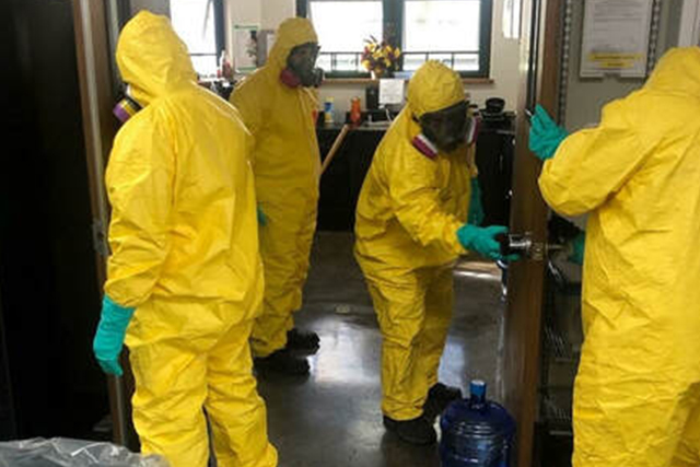 A Patriot Environmental Services emergency response team performing a COVID-19 decontamination to an office building