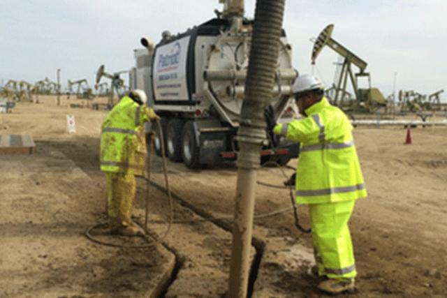 A Patriot Environmental Services team performs hydro excavation in an oilfield to uncover underground piping